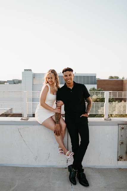 A couple together on a sunlit rooftop, photographed by Logan Ashley